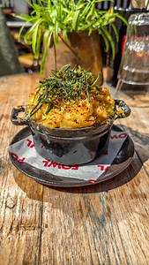 Our crispy, creamy mac and cheese 🧀 made with a rich smoked leek béchamel, three kinds of cheese and topped with crispy leeks ✨ pure comfort | FOWL Restaurant