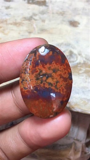 Yazid Ikhsani on Instagram: "From a rough slab to a polished cabochon. This orbicular jasper reveals fiery orange and red orbs as the shape slowly forms. A quiet lapidary process with a bold final reveal. #OrbicularJasper #JasperCabochon #LapidaryArt #StoneCutting #CabochonMaking"