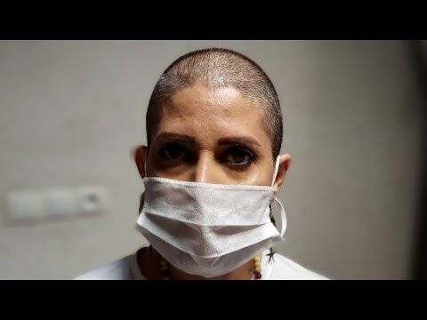 Woman headshave in barbershop by barber