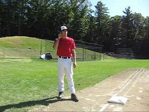 Third base coach giving signals