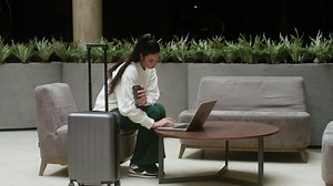 Businesswoman using her laptop in the hotel hall | Free Stock Video Footage