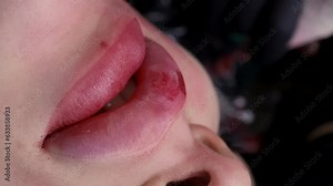 Close-ups of a beautiful model's lips, on which the master is giving permanent lip makeup. High quality 4k footage
