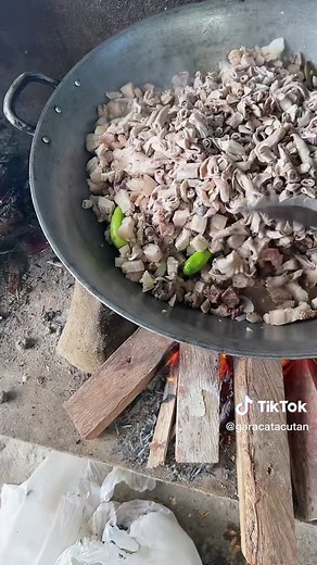 Outdoor Cooking with a Large Metal Wok