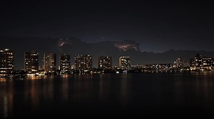 Lightning strikes illuminate dark clouds in time-lapse over Sunny Isles Beach, Florida