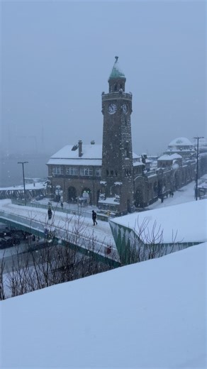 Winter settles gently over Hamburg, wrapping the harbor and the Landungsbrücken in a quiet, snow-dusted calm. ❄️ The usually restless Elbe moves more slowly, reflecting pale skies and the silhouettes of ships waiting patiently at the docks. Snow softens the edges of the piers and rooftops, turning familiar scenes into something timeless. #hamburg #germanytourism #winter | TheModernLeper