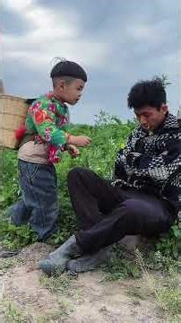 The young man and the old man cook potatoes and eat the cute baby. Rural life. Father and son.
