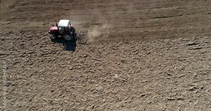A tractor with a spike tooth harrow cuts through clods, manure, and grasses to break up material into finer pieces so that it can be spread evenly across the ground...