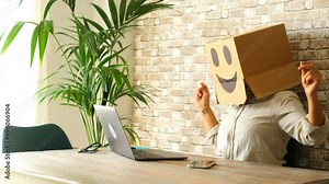 Happy and successful people working on computer wearing smile box on head. Joyful online digital anonymous worker on laptop in video call. Good news on web internet communication leisure