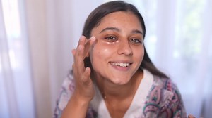 Young beautiful woman applies under eye mask