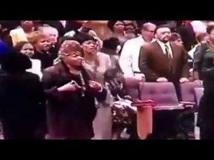 Evangelist Louise Patterson prays for Bishop G.E. Patterson