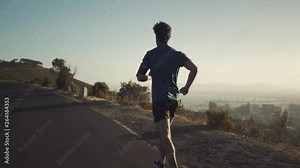 Athletic young man running on the road