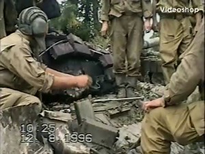 [Chechnya] Russian Soldiers extract the body of a tank crewman out of a T-72 after an armor column was ambushed on the outskirts of Grozny. August of 1996. *NSFW*