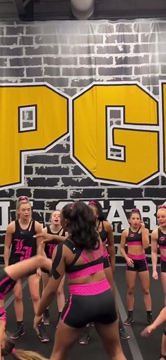 Cheerleaders Showcase Skillful Routines in Pink and Black