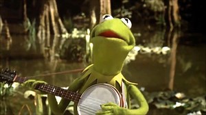 Kermit the Frog (Jim Henson) sings "The Rainbow Connection", as the opening and closing number of The Muppet Movie from 1979.