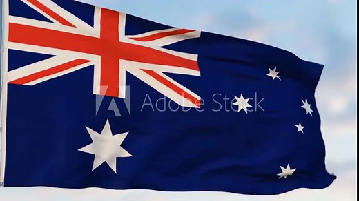 Australian flag waving in the wind against a cloudy sky.