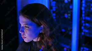 Woman programming in a server room