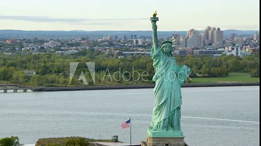 Aerial View Of The Statue Of Liberty Orbiting At Daylight, New York City. New York Aerial Shot. Wide Shot.  US. Flag. United States. High Quality Footage Shot from Helicopter.
