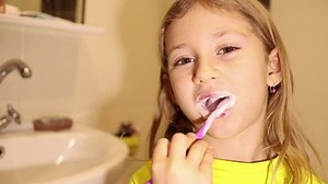 clip-1019383198-little-child-girl-face-portrait-brushing-her
