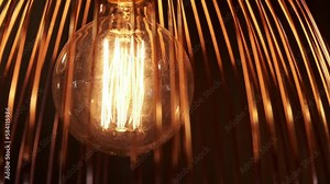 Light bulb with filament flickering due to frequency of electrical current and camera shutter speed