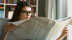 Young Woman Reading Newspaper Stock Footage Video (100% Royalty-free) 20455192 | Shutterstock