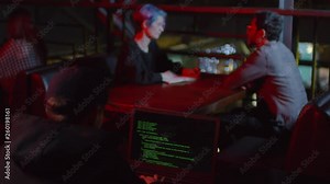 Rare view of hacker sitting in café at laptop and coding