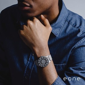 Turn heads with the Bradley Timepiece. Two metal ball bearings are guided around the inner and outer face of the watch by magnets hidden inside its casing. Use the raised hour markers to read the time with both touch and sight. Act now to save 15% on your purchase, use promo code GIFT15. — Photo description: A video slideshow featuring product shots of various Bradley timepieces. | Eone