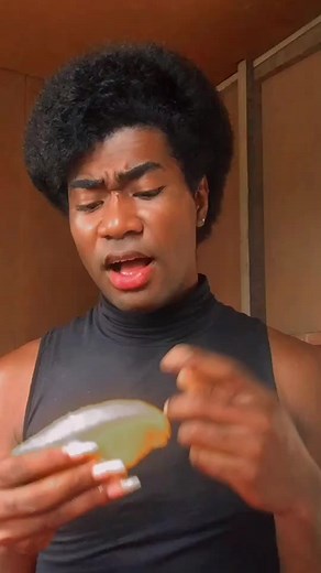 Muscular Individual Squeezes Lemon in Indoor Setting