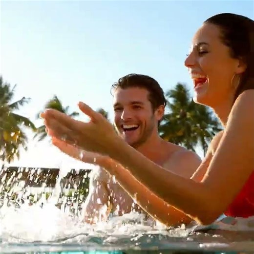 Couple playing in the water / pool and having fun | Royalty free footage