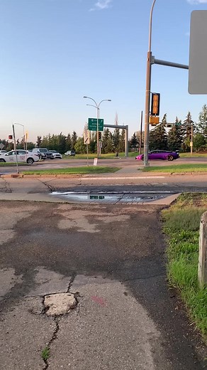 Sleek Purple Lamborghini in Edmonton Intersection