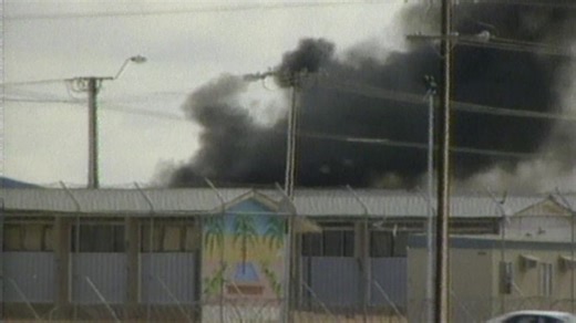 Lateline story from 2000 on the riots at the Woomera immigration detention centre