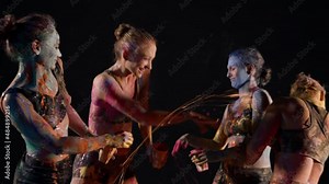 play with paints, smiling ladies are splashing dyes on skin, art performance and fun