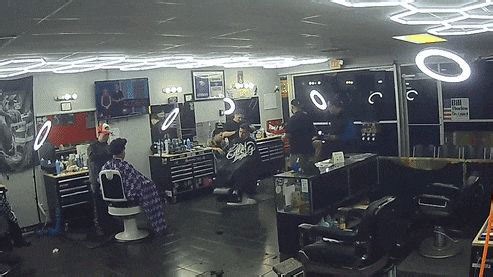 Dramatic moment car smashes into barbershop's front window