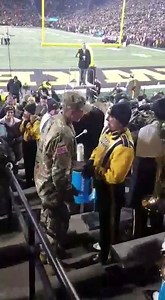 61K views · 3.1K reactions | Grace, a member of the Hawkeye Marching Band, was shocked when her boyfriend, Isaac, came home from officer training and surprised her at Saturday’s football game. Her life changed when he got down on one knee and proposed. Isaac had been the University of Iowa’s drum major for three years and is currently stationed at Fort Benning, Georgia. Both their parents also met in band. Don’t miss the video below. (Turn your sound on!) | University of Iowa | Facebook