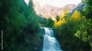 In the heart of the mountains a secret path leads to a hidden waterfall down into a crystal clear pool fed by a majestic mountain stream that sparkles in the afternoon light.