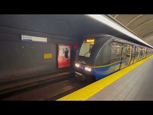 Vancouver Translink Skytrains depart from stations.
