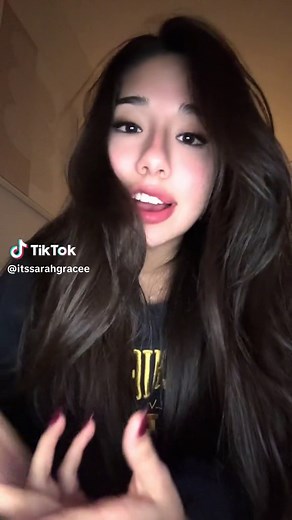 Engaging Gestures with Long Dark Hair and Bright Sweatshirt