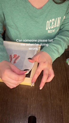 This is my first time putting my needlepoint on stretcher bars and whenever I pull it tight they all pop off, what am I doing wrong? I’m trying to start on diagonals first. Is it just that the pins aren’t long enough? Am I not pushing them in enough?? #needlepoint