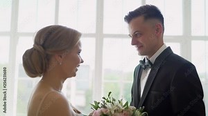 A bride and groom see each other for the first time on their wedding day and share a first look moment before the ceremony. The groom sees the bride for the first time on the wedding day