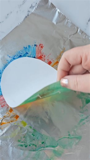 Cut out paper eggs, draw designs with a white crayon. Color markers on a piece of tin foil and spray with water. Press the egg on and lift! | Crafty Morning
