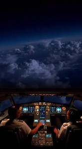 A wide cockpit view during a night holding pattern above a storm system Lightning flashes illuminat | Landing Shots