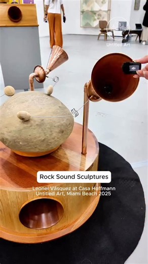 The most interactive artworks at Untitled Art, Miami Beach 2025 (@untitledartfairs) were the sound sculptures by Colombian artist Leonel Vásquez (@leonel_sound_artist). Presented by Casa Hoffmann (@casa_hoffmann), the works feature rocks gathered from rivers in Colombia and generate sound through hand-built analog amplifying systems. Wooden needles, resonant membranes, brass bugles, resonance boxes, and electric motors transform natural materials into immersive instruments. My Modern Met was on