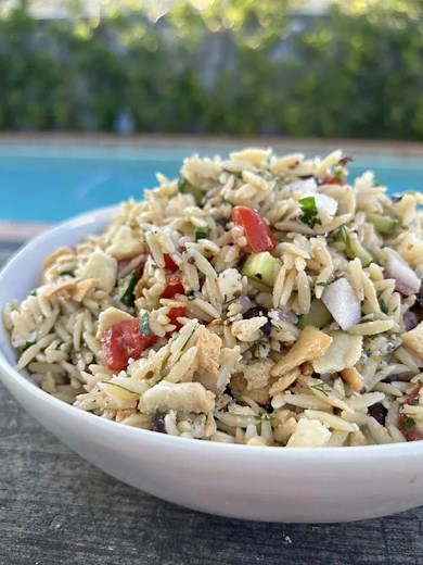 This Greek Orzo Pasta Salad by @Here’s Your Bite is the side dish you'll be bringing to every cookout this summer. 🥗✨ Packed with feta, cucumbers, tomatoes, olives, fresh herbs, and a bright lemon vinaigrette, it's fresh, flavorful, and somehow even better the next day. The best part? You can make it ahead of time, making it perfect for meal prep, potlucks, BBQs, and busy weeknights. Get the full recipe at the link in bio. INGREDIENTS: 6 tbsp olive oil, good quality 2 tbsp lemon juice 2 tsp Dij