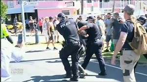 8.5K views · 106 reactions | Almost a thousand people, many without masks, clashed with police on the New South Wales, Queensland border - some swarming a group of officers inside a car. At Tweed Heads, eight people were arrested - while, there were violent scenes at Coolangatta. | NBN Television | Facebook