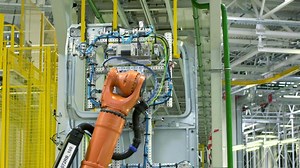 Robotic mechanism, industrial robot iin motion at the modern factory. Scene. Concept of heavy industry and machinery.