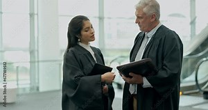 Legal paperwork, discussion and judges in collaboration talking on a court case or criminal investigation. Conversation, document and professional female lawyer speaking to her senior attorney mentor