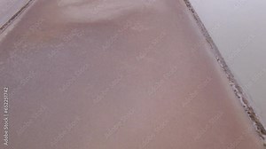 Scale of salt harvesting becomes apparent as pans extend to distant horizon