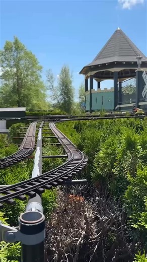 Stepping out the back door of the Kings Castle, one might hear the steady chug of miniature trains weaving through a scaled down town of Charlevoix — rolling past painted storefronts, under tiny bridges, and gliding atop the hedges. Will you come visit to see the model railroad? 🚃🛤️ #modelrailroad #traingarden #castlefarms #touristattraction #charlevoixmichigan #michiganattraction | Castle Farms