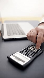 man planning budgets and managing finances. Using a laptop and calculator emphasizes a serious approach to calculations and cost analysis. Concept of financial blogs and consulting materials.