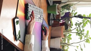 Beautiful female hands and keyboard. A woman works at a computer, vertical video. Typing on keyboard. Distance learning, online education and work on computer