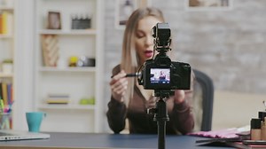 Beauty vlogger talks to subscribers during makeup tutorial - Free Stock Video
